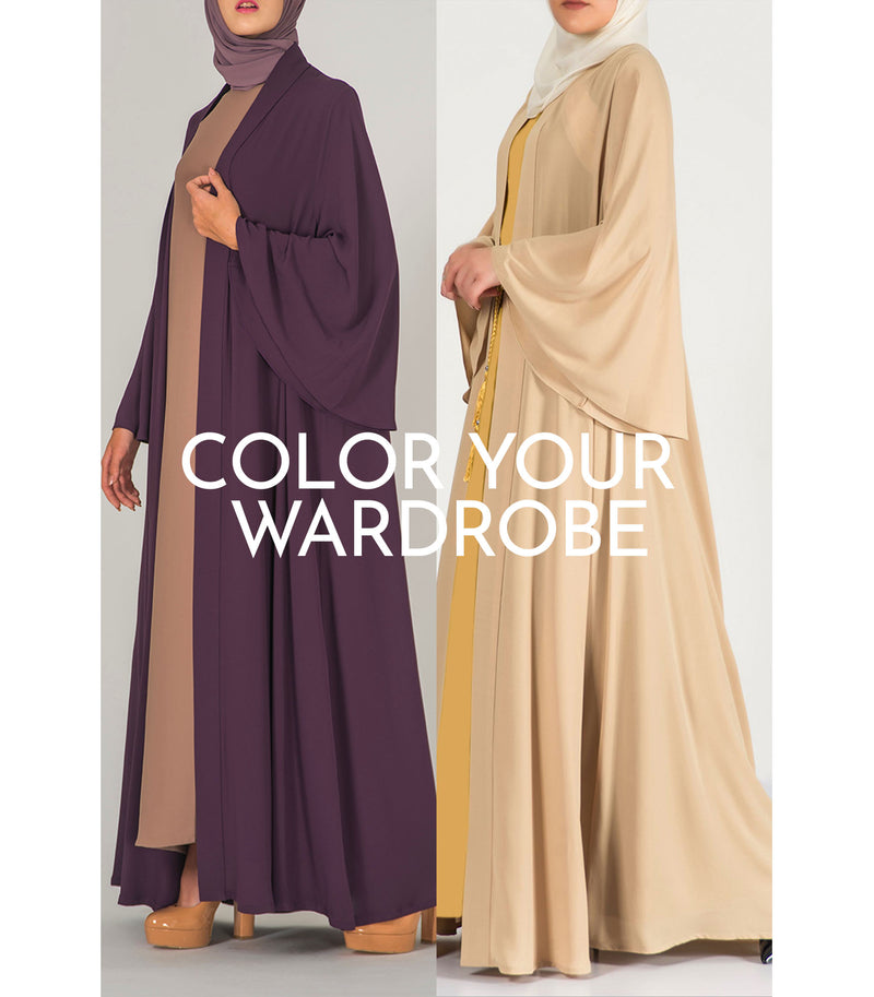 Two women wearing thowby abaya