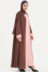 a brown and pink abaya on a white background