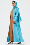 Woman wearing a blue abaya with a brown panel
