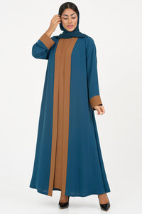 Woman wearing an elegant petrol blue Colored Abaya on a white background