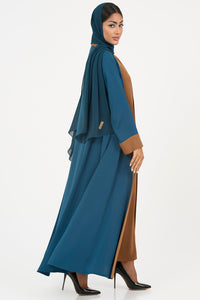 Woman wearing an elegant petrol blue Colored Abaya on a white background