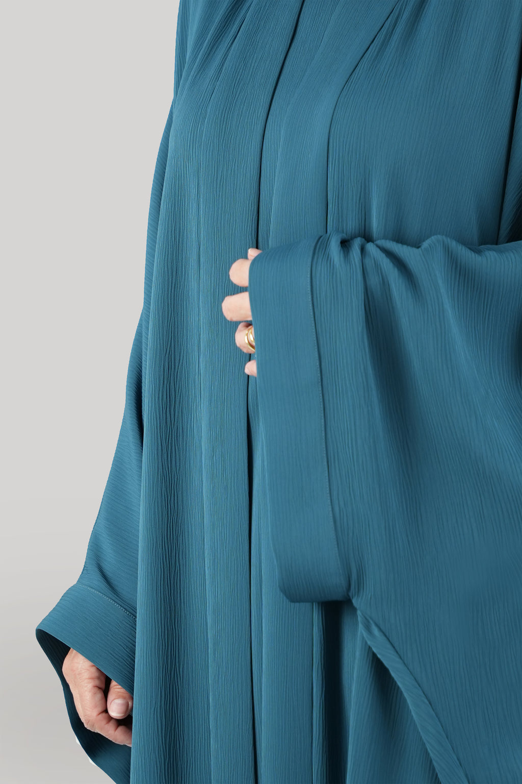 Close up image Rebecca Turquoise Bisht Abaya and under abaya dress