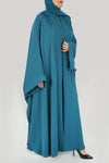 right image Rebecca Turquoise Bisht Abaya and under abaya dress