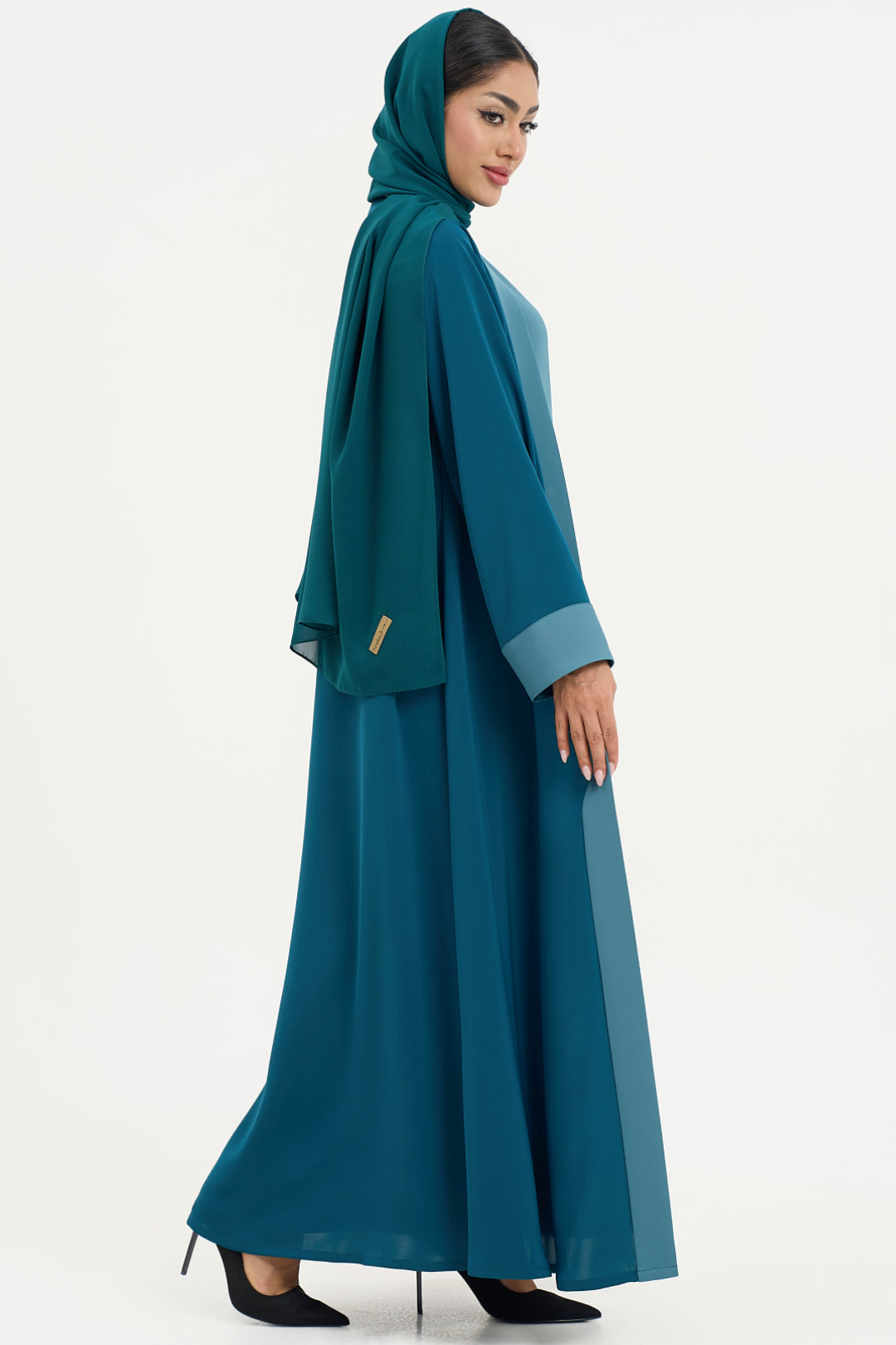 a teal abaya with matching hijab on a white background