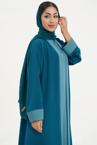 a teal abaya with matching hijab on a white background