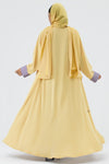 Yellow abaya with purple cuffs on a white background