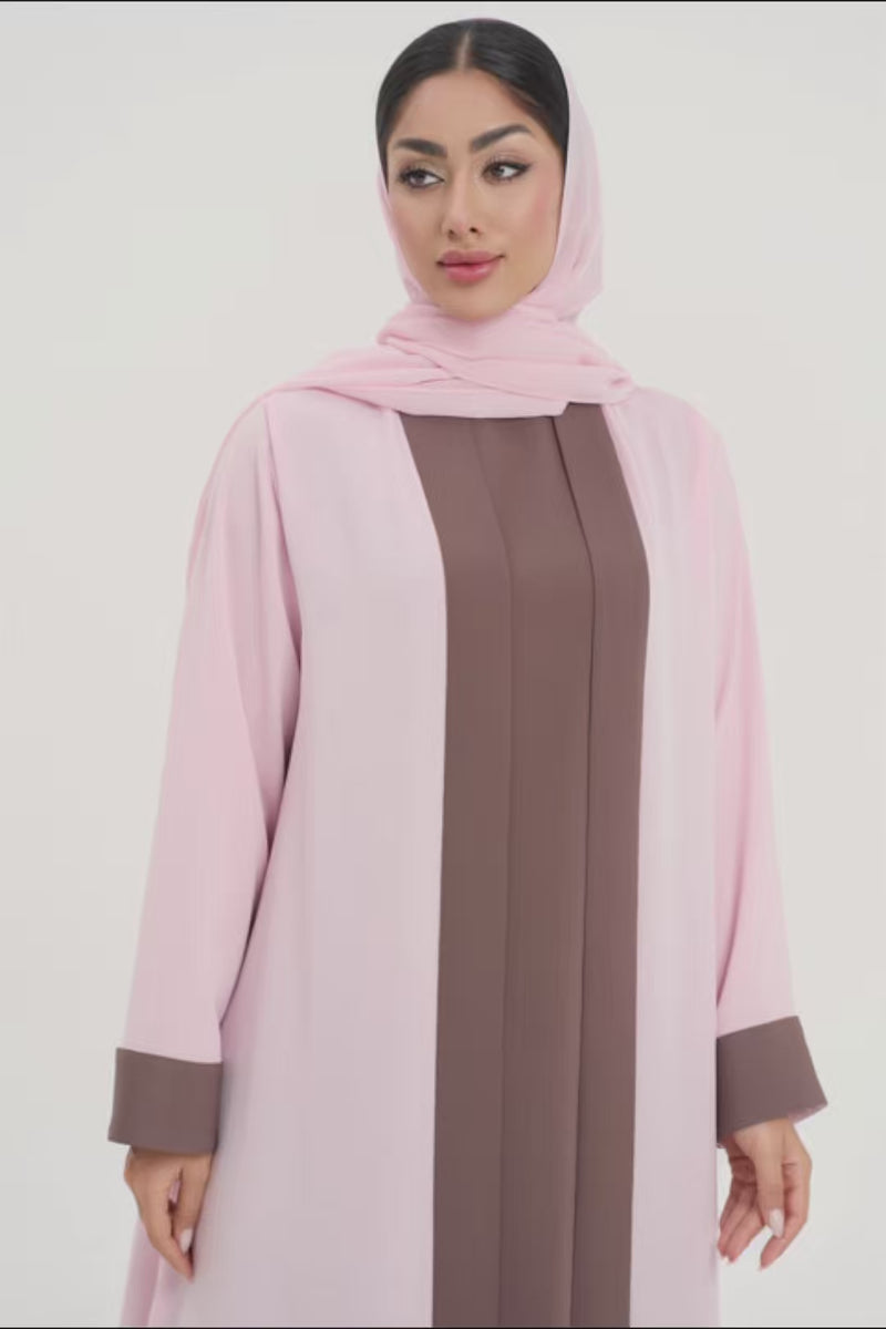 Front view of woman wearing a two-toned baby pink and brown Mayowa abaya