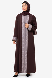 Front view of a woman wearing the Honia Abaya in elegant brown