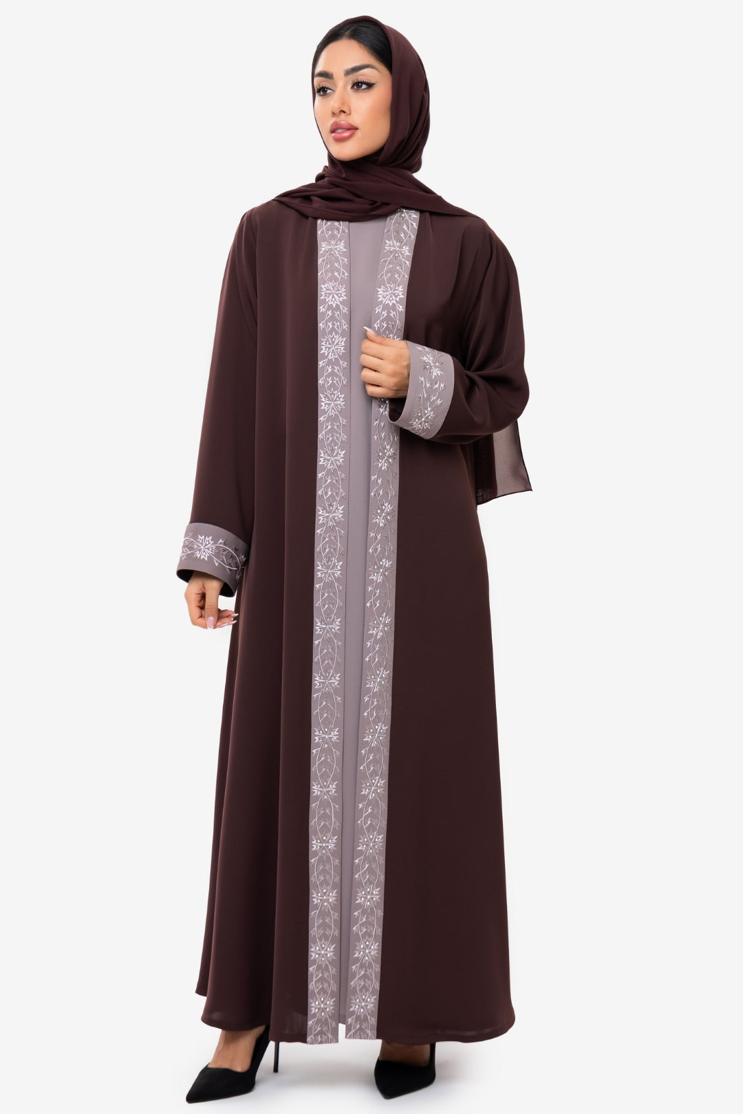 Front view of a woman wearing the Honia Abaya in elegant brown
