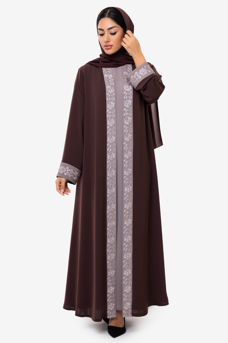 Straight view of a woman wearing the Honia Abaya in elegant brown