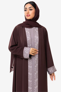 front view of a woman wearing the Honia Abaya in elegant brown