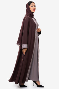 Woman wearing the Honia Abaya in elegant brown facing right side