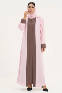 Woman wearing Mayowa abaya in two-tone baby pink and brown, standing straight front pose
