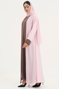 Woman wearing Mayowa abaya in baby pink and brown, standing right side elegant pose