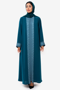 Front view of a woman wearing the Mitra Abaya in elegant teal